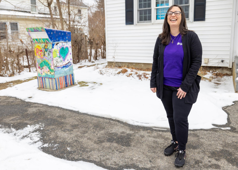 Tonya laughing while standing next to neighborhood book box.