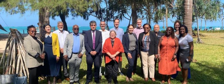 Habitat for Humanity staff and AFI members stand with Professor Marja Hoek-Smit (center) after a masterclass on IASHF in Zanzibar, Tanzania