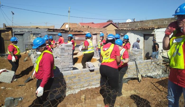 Volunteers engaging in various activities at a build site